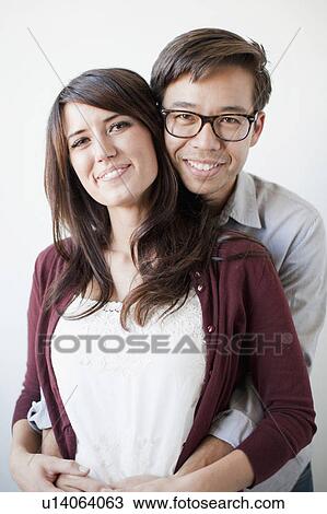 Studio portrait of couple View Large Photo Image Stock Image - Studio portrait of couple. Fotosearch