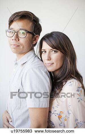 Studio portrait of couple View Large Photo Image Stock Image - Studio portrait of couple. Fotosearch