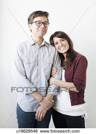 Stock Photo - Studio portrait of couple. Fotosearch