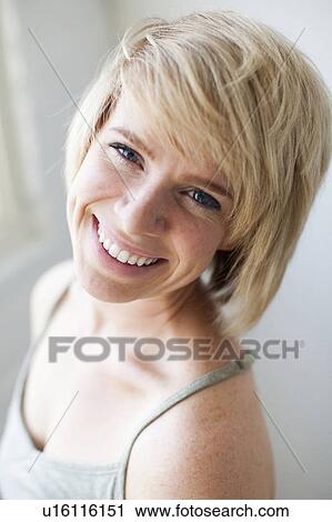Stock Image - Studio portrait of smiling woman. Fotosearch