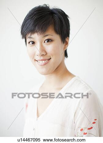 Stock Photography - Studio portrait of smiling woman. Fotosearch