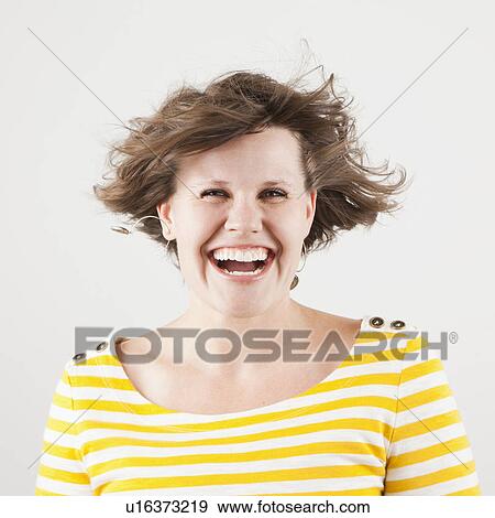 Stock Photo - Studio portrait of woman laughing. Fotosearch