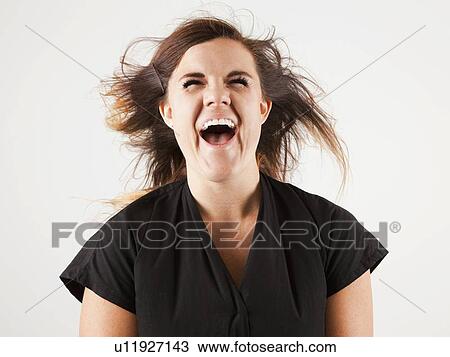 Studio portrait of young woman screaming View Large Photo Image Stock Image - Studio portrait of young woman screaming. Fotosearch