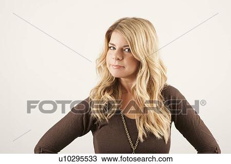 Stock Image - Studio portrait of young woman. Fotosearch