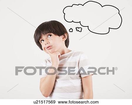 Stock Photo - Studio shot of boy (6-7) with thought bubble. Fotosearch