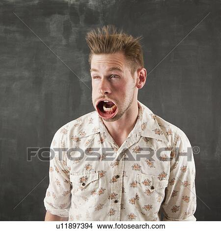 Picture - Studio shot of man with windblown mouth. Fotosearch