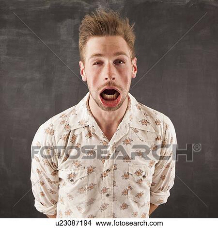 Picture - Studio shot of man with windblown mouth. Fotosearch