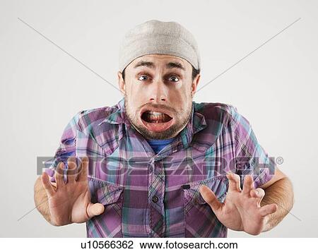 Studio shot of man with windblown mouth View Large Photo Image Stock Image - Studio shot of man with windblown mouth. Fotosearch