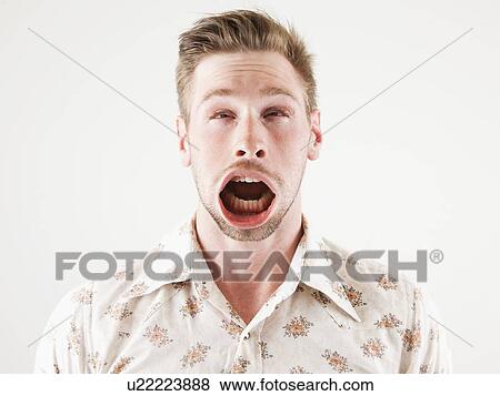Stock Photo - Studio shot of man with windblown mouth. Fotosearch