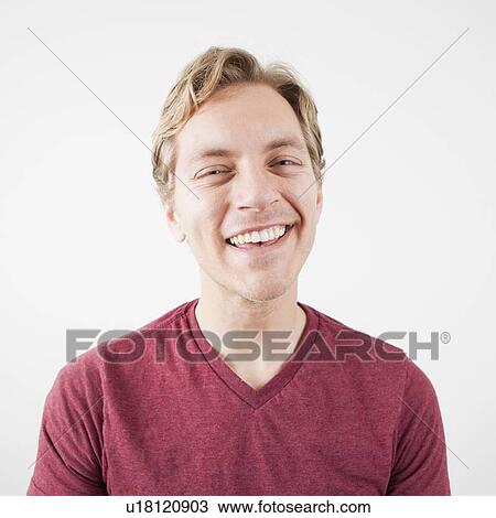Stock Image - Studio Shot of mid adult man expressing happiness. Fotosearch