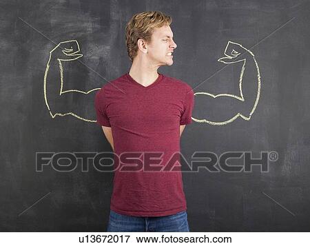 Studio shot of mid adult man with hands behind back and chalk drawing of artificial arms on blackboard View Large Photo Image Stock Photo - Studio shot of mid adult man with hands behind back and chalk drawing of artificial arms on blackboard. Fotosearch