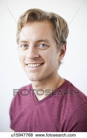 Stock Photo - Studio Shot of young adult man expressing happiness. Fotosearch