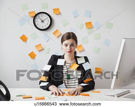 Studio shot of young woman working in office covered with adhesive notes View Large Photo Image Stock Image - Studio shot of young woman working in office covered with adhesive notes. Fotosearch