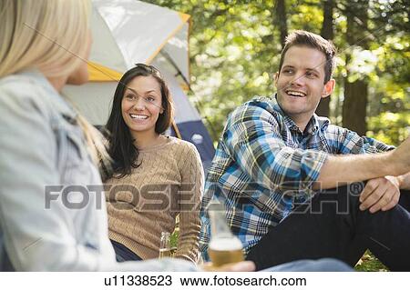 Three friends camping in forest View Large Photo Image Stock Image - Three friends camping in forest. Fotosearch