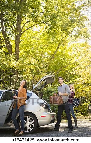 Three friends packing luggage into car View Large Photo Image Stock Photography - Three friends packing luggage into car. Fotosearch