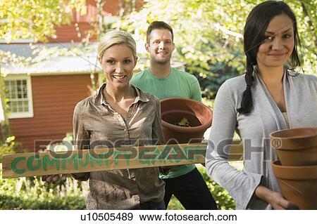 Three friends preparing community garden View Large Photo Image Stock Photo - Three friends preparing community garden. Fotosearch