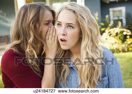 Stock Photo - Two friends gossiping. Fotosearch