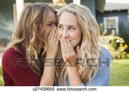 Two friends gossiping View Large Photo Image Stock Photo - Two friends gossiping. Fotosearch