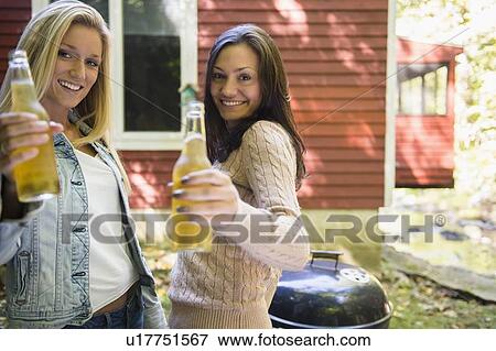 Stock Photo - Two women enjoying barbecue. Fotosearch