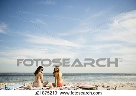 Stock Photo - Two women relaxing on beach. Fotosearch