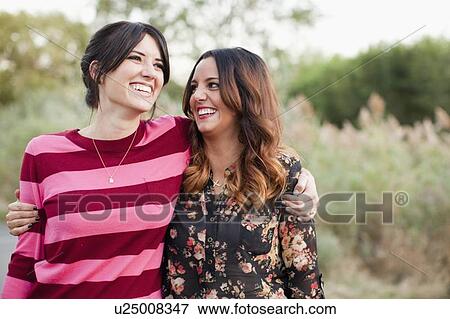 Stock Photo - Two young women embracing. Fotosearch