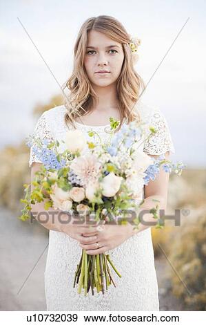 Waist-up portrait of bride holding bunch of flowers View Large Photo Image Stock Photo - Waist-up portrait of bride holding bunch of flowers. Fotosearch