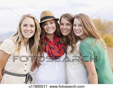 Stock Image - Waist up portrait of four friends. Fotosearch