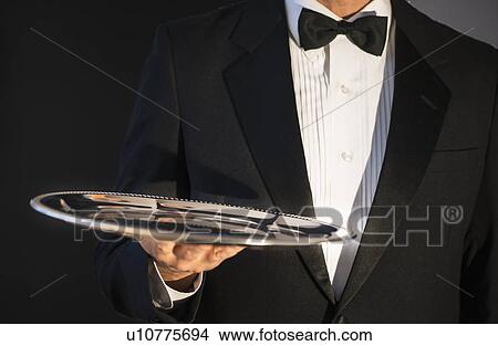 Waiter holding empty tray View Large Photo Image Picture - Waiter holding empty tray. Fotosearch