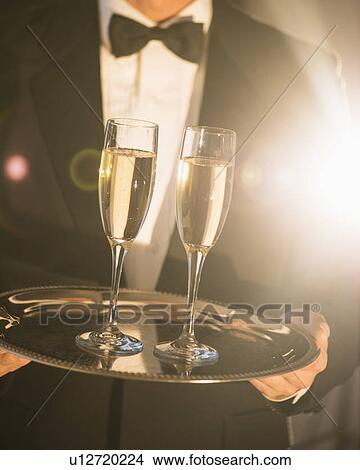 Waiter holding tray with champagne View Large Photo Image Picture - Waiter holding tray with champagne. Fotosearch