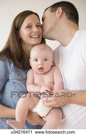 Woman and man holding baby boy (2-5 months) View Large Photo Image Stock Image - Woman and man holding baby boy (2-5 months). Fotosearch