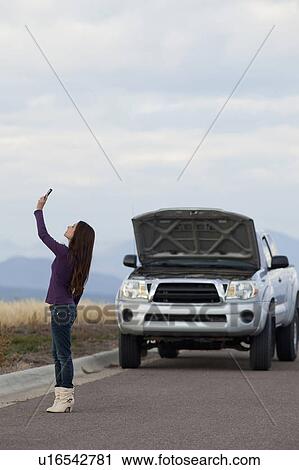 Woman calling for assistance after vehicle breakdown View Large Photo Image Stock Image - Woman calling for assistance after vehicle breakdown. Fotosearch