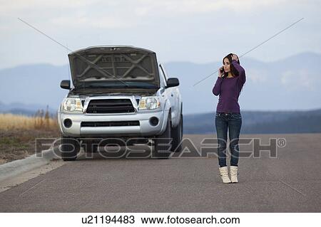 Woman calling for assistance after vehicle breakdown View Large Photo Image Stock Image - Woman calling for assistance after vehicle breakdown. Fotosearch