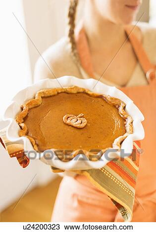 Woman holding pumpkin pie View Large Photo Image Stock Image - Woman holding pumpkin pie. Fotosearch