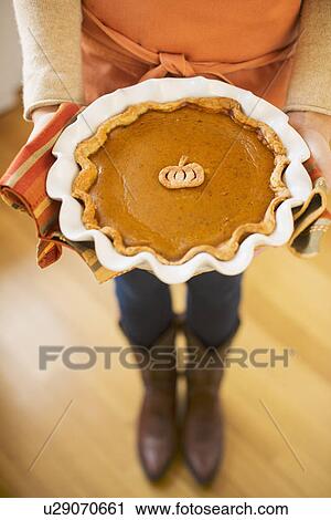 Woman holding pumpkin pie View Large Photo Image Stock Image - Woman holding pumpkin pie. Fotosearch