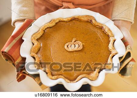 Woman holding pumpkin pie View Large Photo Image Stock Photograph - Woman holding pumpkin pie. Fotosearch