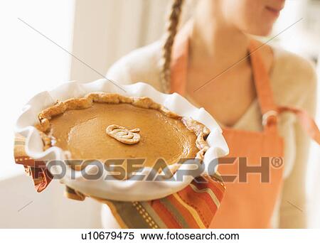 Woman holding pumpkin pie View Large Photo Image Stock Photography - Woman holding pumpkin pie. Fotosearch