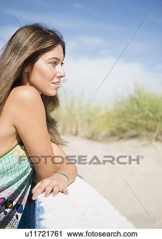 Woman relaxing on beach View Large Photo Image Stock Image - Woman relaxing on beach. Fotosearch