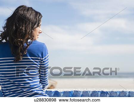 Woman relaxing on beach View Large Photo Image Stock Photo - Woman relaxing on beach. Fotosearch