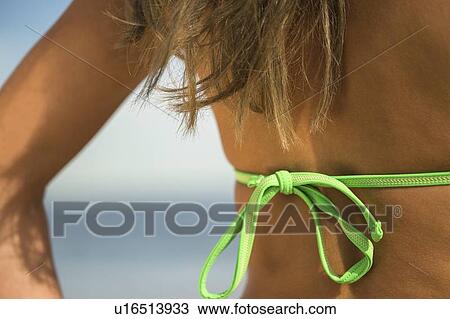 Stock Image - Woman sunbathing at beach. Fotosearch