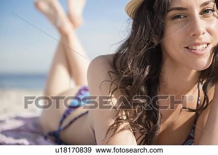 Woman sunbathing on beach View Large Photo Image Stock Photo - Woman sunbathing on beach. Fotosearch