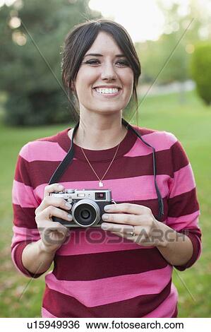 Woman using old camera View Large Photo Image Stock Photograph - Woman using old camera. Fotosearch