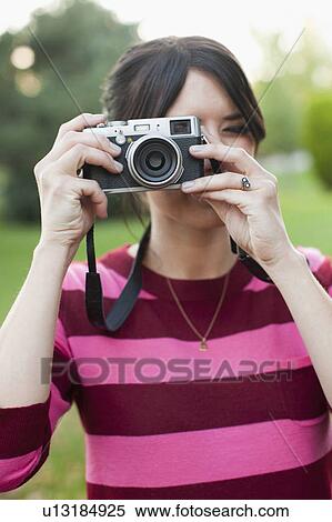 Woman using old camera View Large Photo Image Stock Photography - Woman using old camera. Fotosearch