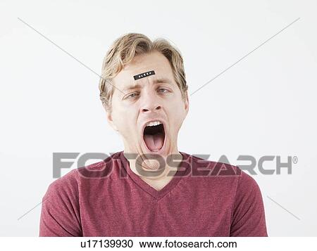 Yawning man with sticker on his forehead View Large Photo Image Stock Image - Yawning man with sticker on his forehead. Fotosearch
