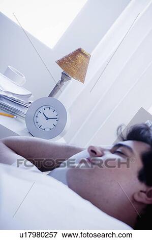 Young man sleeping in bed View Large Photo Image Stock Photo - Young man sleeping in bed. Fotosearch