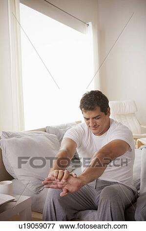 Young man stretching after waking up View Large Photo Image Stock Photo - Young man stretching after waking up. Fotosearch
