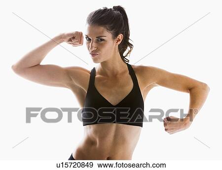 Young showing biceps, studio shot View Large Photo Image Stock Photo - Young showing biceps, studio shot. Fotosearch