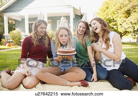 Young woman celebrating her birthday with friends View Large Photo Image Stock Photography - Young woman celebrating her birthday with friends. Fotosearch