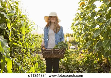 Picture - Young woman gardening. Fotosearch