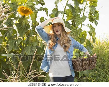Stock Photo - Young woman gardening. Fotosearch