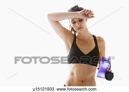 Young woman resting after exercising, studio shot View Large Photo Image Stock Image - Young woman resting after exercising, studio shot. Fotosearch